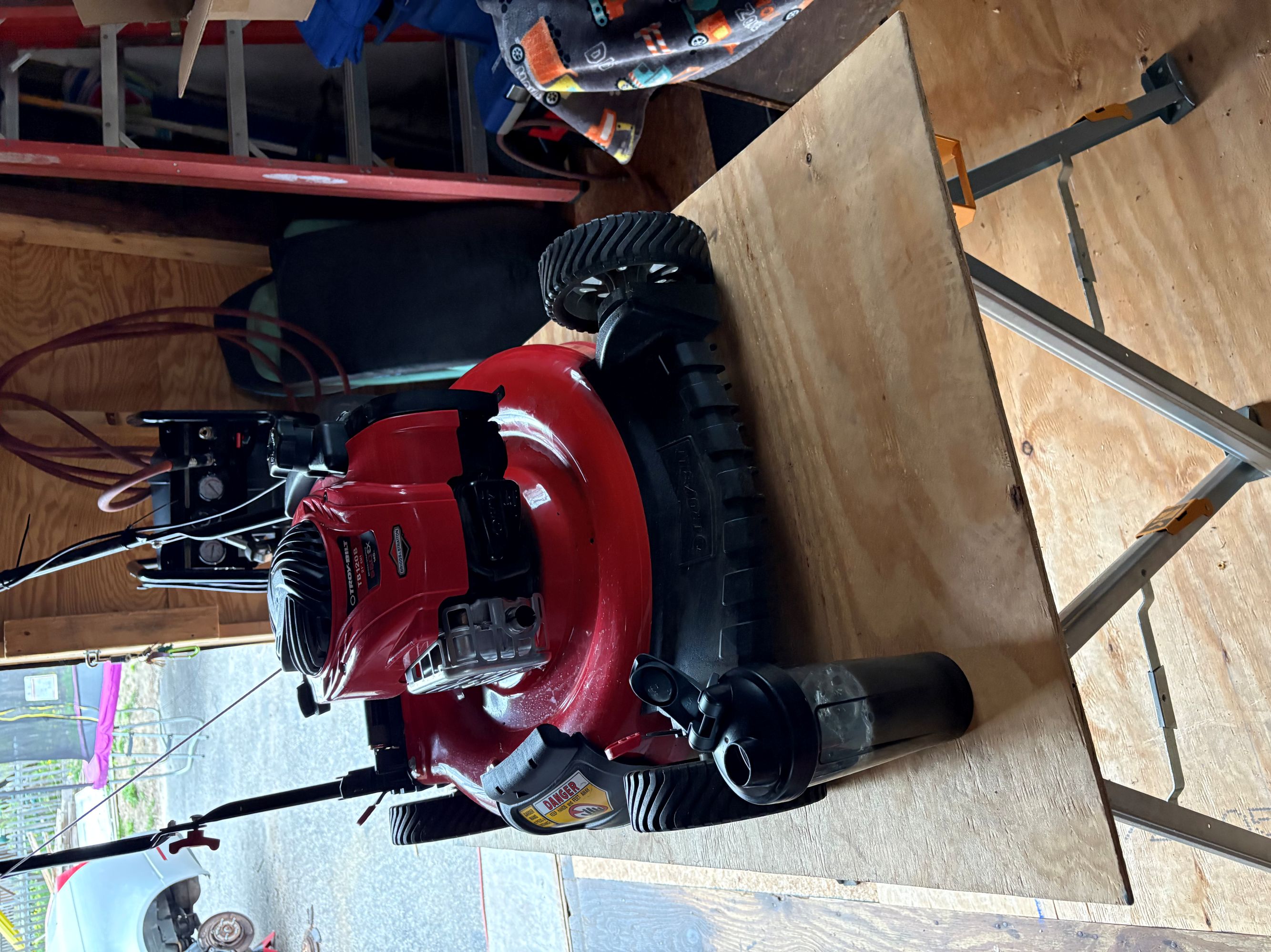 Troy-Bilt mower on sawhorses in the garage