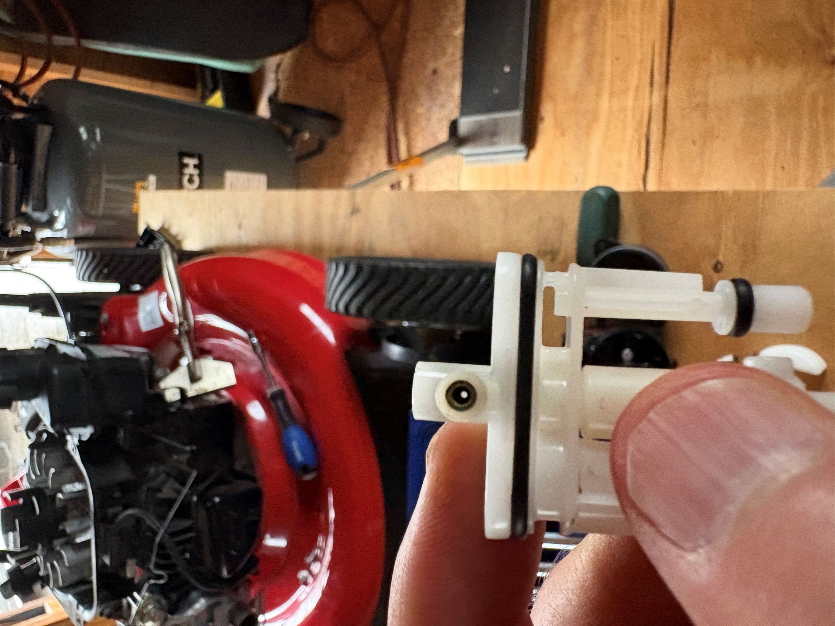 Carburetor jet assembly held for inspection